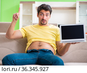 Man suffering from extra kilos in dieting concept. Стоковое фото, фотограф Elnur / Фотобанк Лори