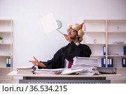 Funny young male employee magician and too much work in the office. Стоковое фото, фотограф Elnur / Фотобанк Лори