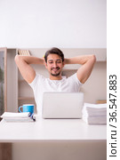 Young male freelancer working from home. Стоковое фото, фотограф Elnur / Фотобанк Лори
