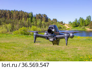Moscow, 31 MAY 2021 : A new DJI FPV drone is flying during a sunny day on grass in beckground. Top Front View. Headless Quadcopter with Digital 4K 60 fps Hasselblad Camera and Remote Control. Стоковое фото, фотограф Алексей Ширманов / Фотобанк Лори