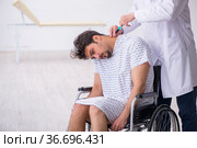 Old male doctor psychiatrist examining young disabled patient. Стоковое фото, фотограф Elnur / Фотобанк Лори