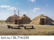 Arkaim, Russia - August, 24, 2021: Archaeological reconstruction of a Stone Age dwelling, exterior. Редакционное фото, фотограф Вадим Орлов / Фотобанк Лори