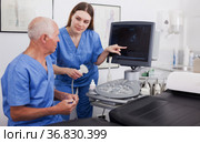 elderly doctor and nurse in cabinet of ultrasound test. Стоковое фото, фотограф Яков Филимонов / Фотобанк Лори