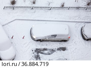 Vehicle standing at winter parking place, working engine car covering with snow, top view. Стоковое фото, фотограф Кекяляйнен Андрей / Фотобанк Лори