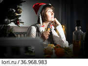 Bored woman watching Christmas tv program. Стоковое фото, фотограф Яков Филимонов / Фотобанк Лори