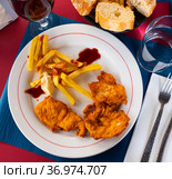Crisp chicken nuggets with golden brown crust and french fries. Стоковое фото, фотограф Яков Филимонов / Фотобанк Лори