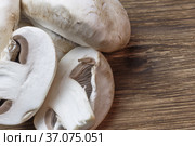 Food background. Sliced champignon mushroom close-up. Low-calorie product, a source of vitamin B1, B2, B6, B12, D6, D12, nicotinic pantothenic acid, iron, zinc, calcium, iodine, phosphorus, protein. Стоковое фото, фотограф Светлана Евграфова / Фотобанк Лори