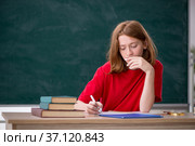 Young female student preparing for exams in the classroom. Стоковое фото, фотограф Elnur / Фотобанк Лори