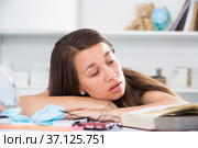 Teenage girl is sleeping after studying. Стоковое фото, фотограф Яков Филимонов / Фотобанк Лори