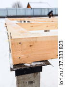 Close up view at conection of square-sawn timbers as beams for flooring over concrete pile foundation. Стоковое фото, фотограф Кекяляйнен Андрей / Фотобанк Лори
