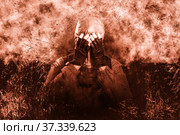 A shot of a man dressed in a gas mask, a jacket with a hood, a backpack, covered his face with his hands from dissuasion and trouble. A poster on the background of grunge. Стоковое фото, фотограф Владимир Арсентьев / Фотобанк Лори