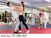 Woman performing eye-gouging move during self-defence training. Стоковое фото, фотограф Яков Филимонов / Фотобанк Лори