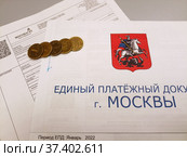 Единый платежный документ за 2022 год и счет за газ в частном доме. Монеты на платежных документах. Редакционное фото, фотограф Владимир Сперанский / Фотобанк Лори