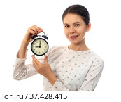Woman holding black alarm clock. Стоковое фото, фотограф Людмила Дутко / Фотобанк Лори
