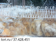 One of the most famous places in the Republic of Karelia is the Ruskeala waterfalls (the filming location of the Soviet film "The Dawns Here Are Quiet...") in the winter season. Traveling in Russia, Republic of Karelia. Стоковое фото, фотограф Алексей Кокоулин / Фотобанк Лори