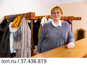 Smiling elderly woman checkroom attendant working in theater. Стоковое фото, фотограф Яков Филимонов / Фотобанк Лори