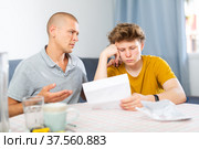Depressed father and son reading letter. Стоковое фото, фотограф Яков Филимонов / Фотобанк Лори