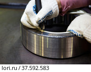 Stepnogorsk, Kazakhstan - April 04, 2012: Bearing production plant. Engraving ready bearing with electric-arc pencil. Стоковое фото, фотограф Alexey Rezvykh / Фотобанк Лори