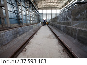 Grey concrete interior of new industrial building. Phosphoric fertilizers plant. New factory workshop construction. Стоковое фото, фотограф Alexey Rezvykh / Фотобанк Лори
