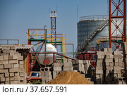 Galvanizing heat exchanger tank (boiler) on oil refinery plant in yellow desert on blue sky background. Стоковое фото, фотограф Alexey Rezvykh / Фотобанк Лори