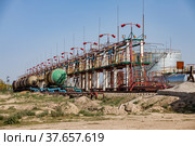 Railway filling station or terminal on oil refinery plant in desert. Anti-fire system and extinguishers. Blue sky. Kazakhstan, Taraz city. (2012 год). Редакционное фото, фотограф Alexey Rezvykh / Фотобанк Лори