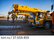 Turkestan, Kazakhstan - April 29, 2012: Yellow construction machines on parking. Hydraulic hoist trucks. Редакционное фото, фотограф Alexey Rezvykh / Фотобанк Лори