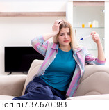 Young woman finding out about her pregnancy. Стоковое фото, фотограф Elnur / Фотобанк Лори