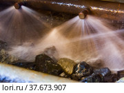 Blurred photo background. Water jets and ore rocks. Washing gold ore on concentrating plant. Khromtau, Mechel, Kazakhstan. Стоковое фото, фотограф Alexey Rezvykh / Фотобанк Лори