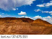 ore mining, quarry, soil, mining industry, hill, dump, aluminium, bauxite, clay, ore mining, empty rock, beautiful, blue sky, background, cloud, color, desert, dry, environment, gangue, geology, green, industrial, industry, landscape, mine, mountain, nature, no one, no people, open cast, open cut, orange, outdoor, red, rock, scenic, sky, spoil, stone, summer, yellow. Стоковое фото, фотограф Alexey Rezvykh / Фотобанк Лори