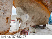 Mangystau, Kazakhstan - May 19, 2012: Old rusted ship on Bautino ship-repairing yard. Close-up of water propeller and ship's bottom with shellbacks. Стоковое фото, фотограф Alexey Rezvykh / Фотобанк Лори