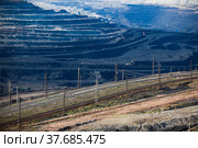 Open pit extraction of coal in quarry "Bogatyr", Ekibastuz, Kazakhstan. Quarry truck, excavators and railroad. Стоковое фото, фотограф Alexey Rezvykh / Фотобанк Лори