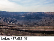 Open pit extraction of coal in quarry "Bogatyr", Ekibastuz, Kazakhstan. Quarry truck, excavators and train. Panoramic view. Light blue sky. Стоковое фото, фотограф Alexey Rezvykh / Фотобанк Лори