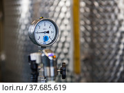 Ekibastuz, Kazakhstan - May 28, 2012. Explosive material production plant for coal quarry mining. Manometer gauge close up. Stainless steel tank on background. Стоковое фото, фотограф Alexey Rezvykh / Фотобанк Лори