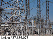 Close-up of Electrical Distribution and transformer substation. Blue sky background. Стоковое фото, фотограф Alexey Rezvykh / Фотобанк Лори