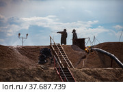 Mining and processing plant. Chemist use sodium cyanide NaCN for gold refining. Hazmat suits and gas masks. Almaty region, Kazakhstan. Стоковое фото, фотограф Alexey Rezvykh / Фотобанк Лори