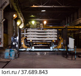Temirtau, Kazakhstan - June 09, 2012: Concrete sleepers manufacturing plant NORD Prom NS workshop. Stack of ready sleepers. No people. Редакционное фото, фотограф Alexey Rezvykh / Фотобанк Лори