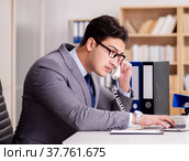 Businessman speaking on phone in office. Стоковое фото, фотограф Elnur / Фотобанк Лори