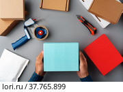 Above table top view of warehouse preparing post courier delivery package. Стоковое фото, фотограф Сергей Толмачёв / Фотобанк Лори