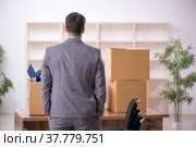 Young male employee in office relocation concept. Стоковое фото, фотограф Elnur / Фотобанк Лори