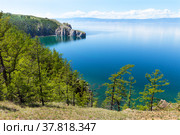 Beautiful summer landscape of Baikal Lake on a June sunny day. View of the rocky cape Three Brothers, popular with tourists, on Olkhon Island. Natural background. Summer holidays and travel. Стоковое фото, фотограф Виктория Катьянова / Фотобанк Лори
