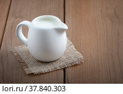 White jug with milk on a wooden rustic background. Стоковое фото, фотограф Наталия Попова / Фотобанк Лори