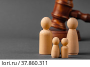 Wooden toy family and judge mallet. Family divorce concept. Стоковое фото, фотограф Сергей Толмачёв / Фотобанк Лори