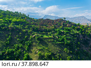 Ruins of houses on a mountainside in Kurib, a depopulated village with the only remaining household with an apiary, Dagestan. Стоковое фото, фотограф Евгений Харитонов / Фотобанк Лори