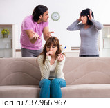 Young family and mother-in-law in family issues concept. Стоковое фото, фотограф Elnur / Фотобанк Лори