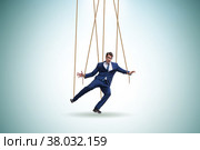 Businessman puppet being manipulated by ropes. Стоковое фото, фотограф Elnur / Фотобанк Лори