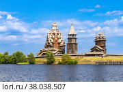 View to old monastery Kizhi Pogost, wooden Temple and Churchyard. Church of Transfiguration, bell tower in summer at sunset. Natural ecological clean island in Onega lake, Republic of Karelia, Russia. Стоковое фото, фотограф Алексей Ширманов / Фотобанк Лори