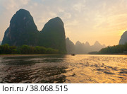 China. Yangshuo. Xingping. Unusual landscape of the exotic Li River with beautiful karst hills at sunset. Natural background (2011 год). Стоковое фото, фотограф Виктория Катьянова / Фотобанк Лори