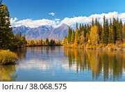 Siberian autumn beautiful landscape with the Eastern Sayan Mountains. Yellowed trees are reflected in the Irkut River. Baikal region, Buryatia, Tunka Valley. Стоковое фото, фотограф Виктория Катьянова / Фотобанк Лори