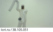 Strange silhouette of man in chemical protection suite with very long sleeves. Стоковое видео, видеограф Aleksey Kidisyuk / Фотобанк Лори