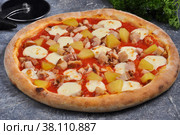 Hawaiian pizza on a gray background decorated with greenery. Стоковое фото, фотограф Дмитрий Ульянов / Фотобанк Лори